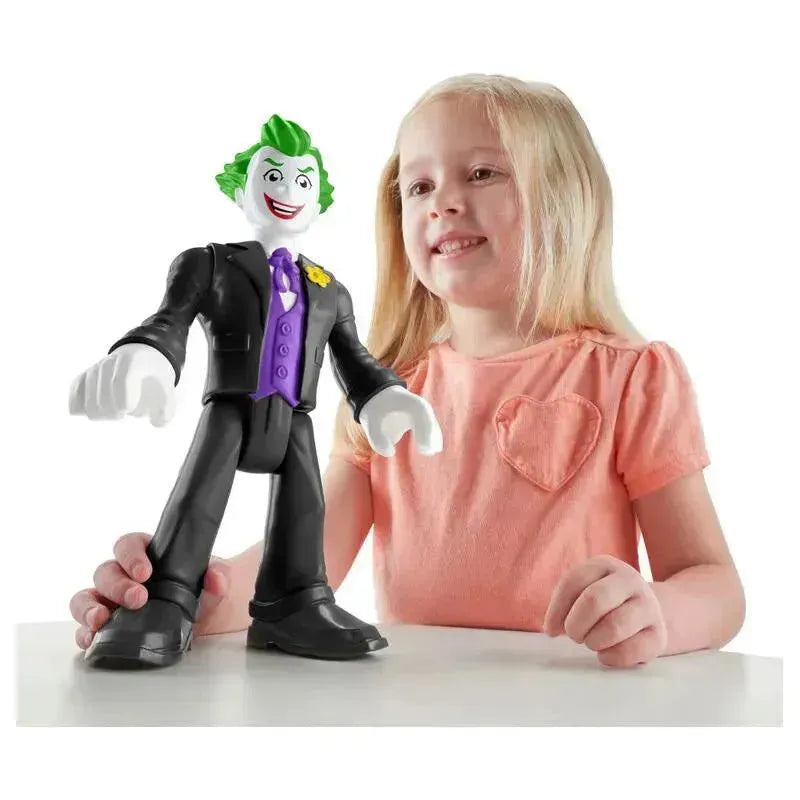 Fisher Price Imaginext DC Super Friends Joker toy, featuring a smiling child playing with the figure on a table.
