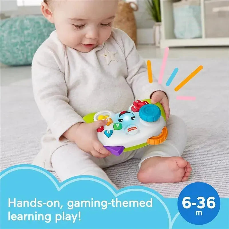 Fisher Price Laugh & Learn Baby Controller toy held by a smiling baby, featuring bright buttons and vibrant colors for interactive play.