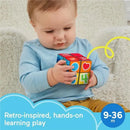 Toddler playing with the Fisher Price Laugh & Learn Activity Cube, featuring colorful numbers and shapes for learning.