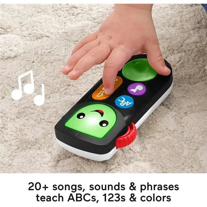 Fisher-Price Laugh & Learn Stream & Learn Remote with colorful buttons and a smiling face, used by a child’s hand, teaching songs and phrases.