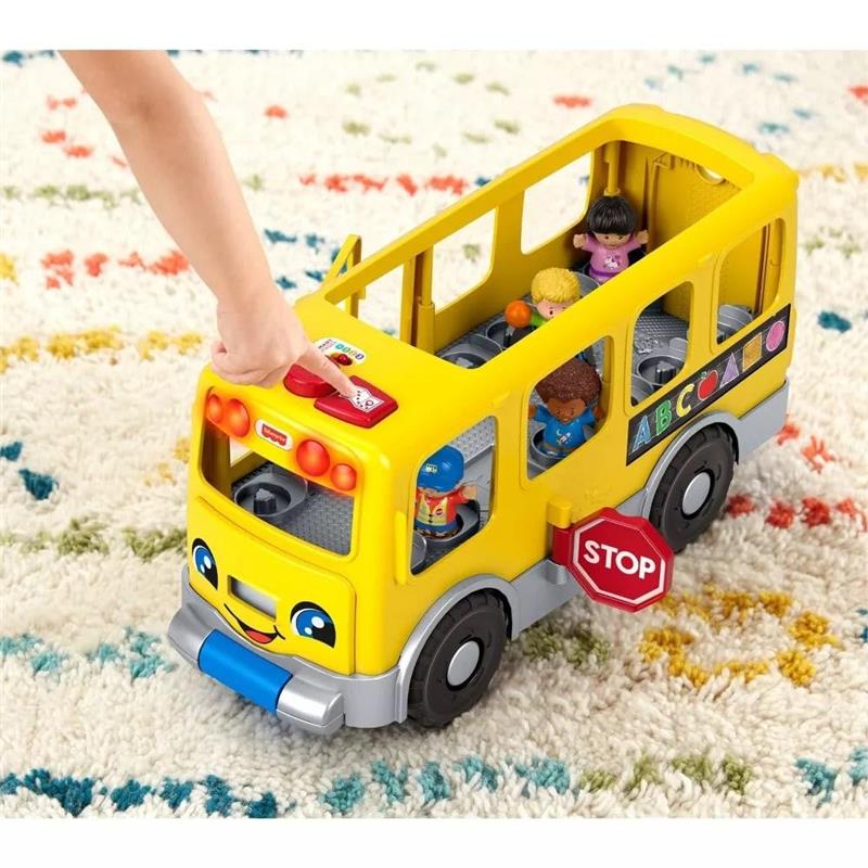 Yellow school bus toy with smiling face, buttons, and Little People figures inside, set on a colorful rug.