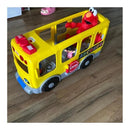 Yellow school bus toy with Elmo and a small doll inside, featuring buttons and ABC tiles for interactive learning.