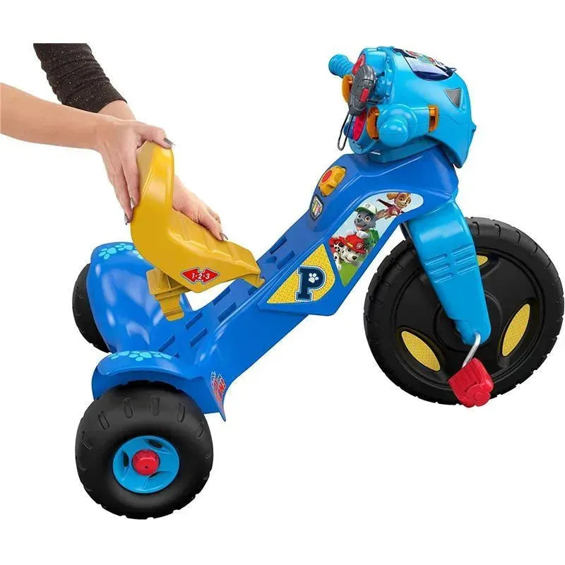 Fisher Price Paw Patrol tricycle with a blue frame, large wheels, and colorful character decals, featuring a removable yellow seat.