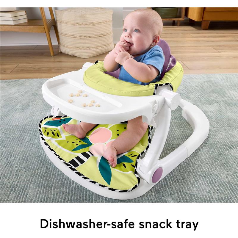 Portable baby chair with a colorful seat and dishwasher-safe snack tray; baby sitting upright, engaged and exploring.