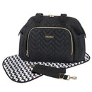 Quilted black diaper bag tote with a gold zipper, adjustable strap, and a patterned changing mat.