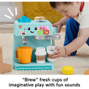 Toddler playing with Fisher Price Laugh & Learn Coffee Café, featuring colorful cups and buttons for educational sounds.