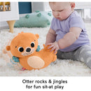 Plush orange otter toy designed for sensory play, with a child engaged in interaction on a soft rug.