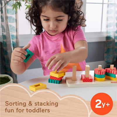 Fisher Price wooden toddler shape stacker toy with colorful blocks; a child assembling shapes on a table.