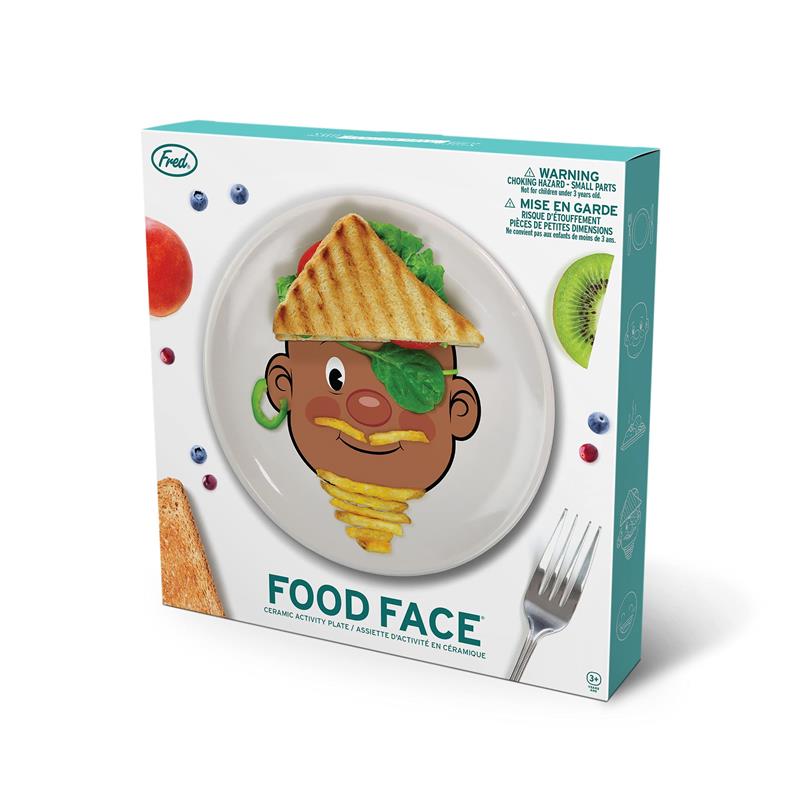 Ceramic dinner plate featuring a cartoon face design, with food items arranged to create a playful character.