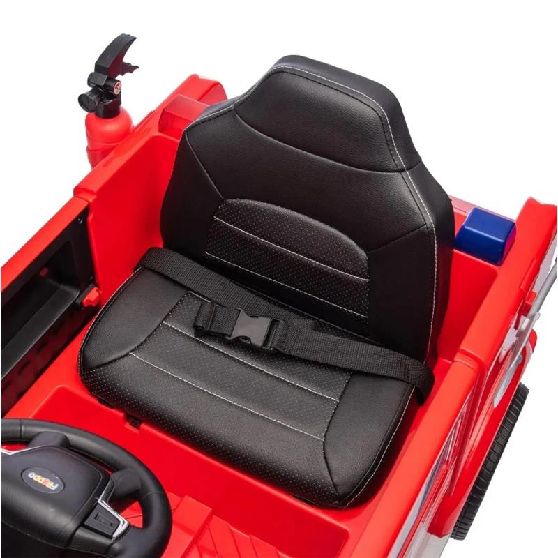 Black cushioned seat with a safety belt in a red toy fire truck, featuring a steering wheel and fire extinguisher.