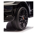 Black wheel of a Freddo 24V Porsche Macan Turbo EV ride-on toy, featuring detailed rim design and tire tread.