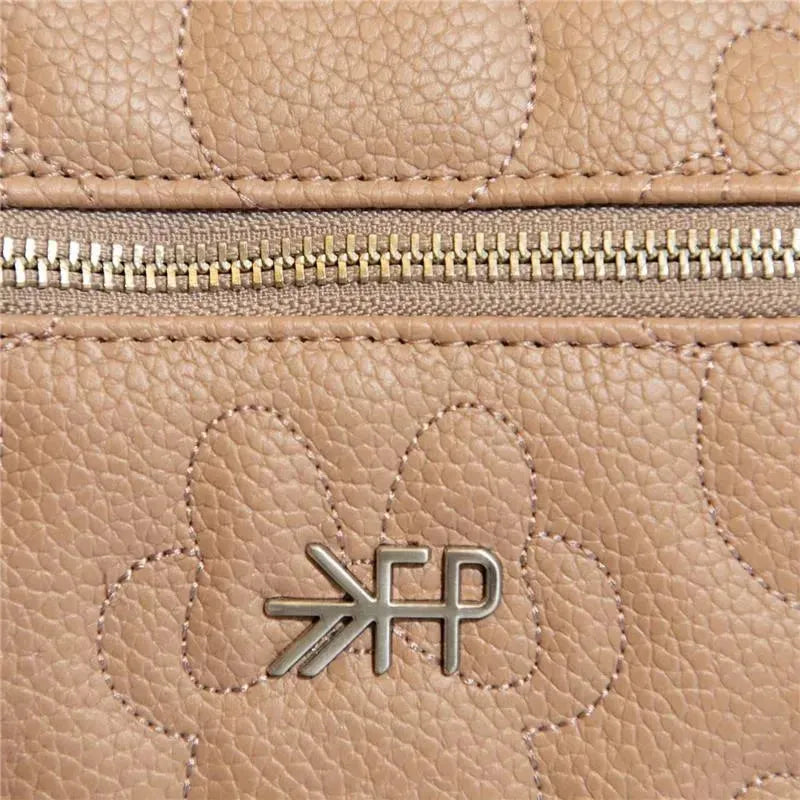 Minimalist beige leather backpack featuring floral embossed design and a metallic Freshly Picked logo.