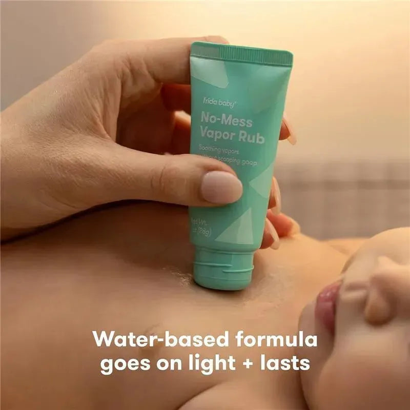 Frida Baby No-Mess Vapor Rub tube held by a hand, with a baby resting nearby, showcasing soothing eucalyptus and lavender properties.
