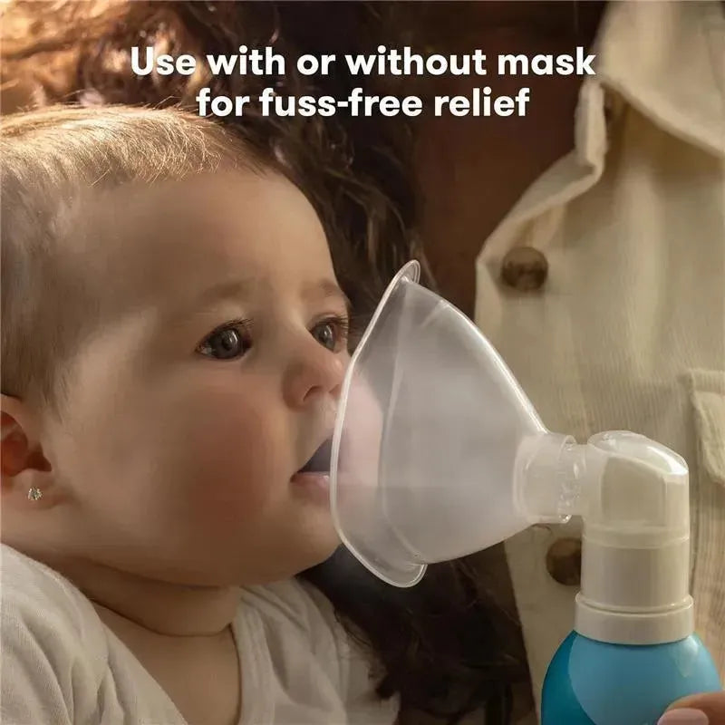 Nasal inhaler used on a baby for soothing stuffy nose, featuring a clear inhalation mask and a blue saline mist bottle.
