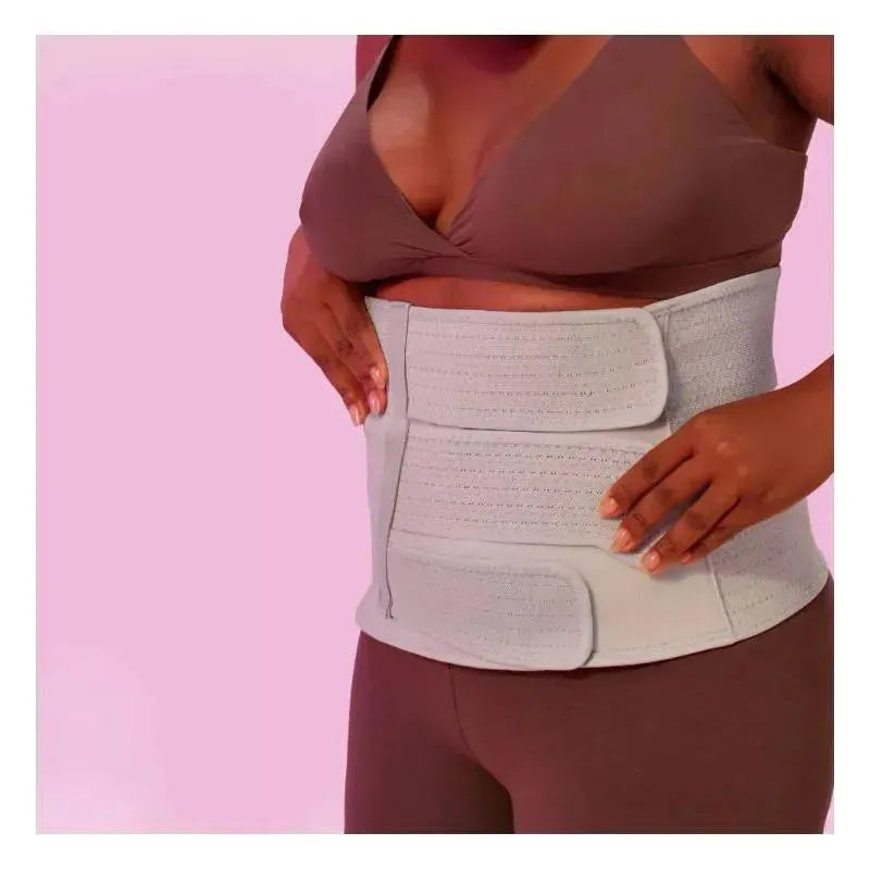 Postpartum abdominal support binder worn by a woman, designed for abdominal support after childbirth.