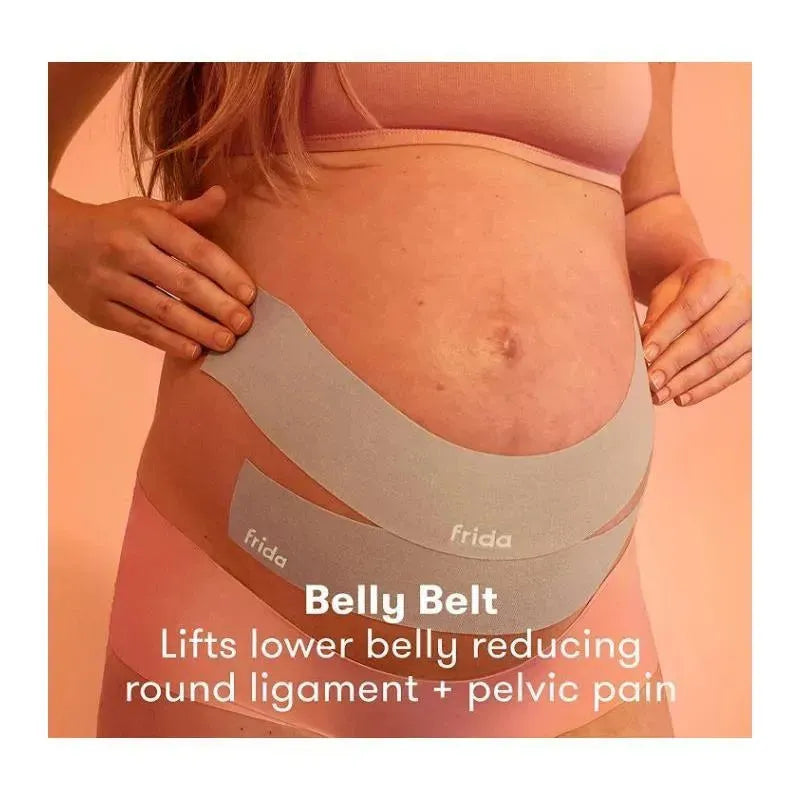 Pregnant person applying Frida Mom Belly Belt, designed to lift the lower belly and alleviate round ligament and pelvic pain.