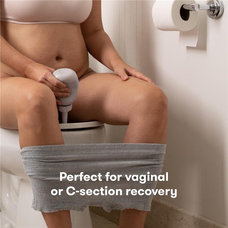 Upside Down Peri Bottle sprayer in gray, being used for postpartum care while seated on a toilet.