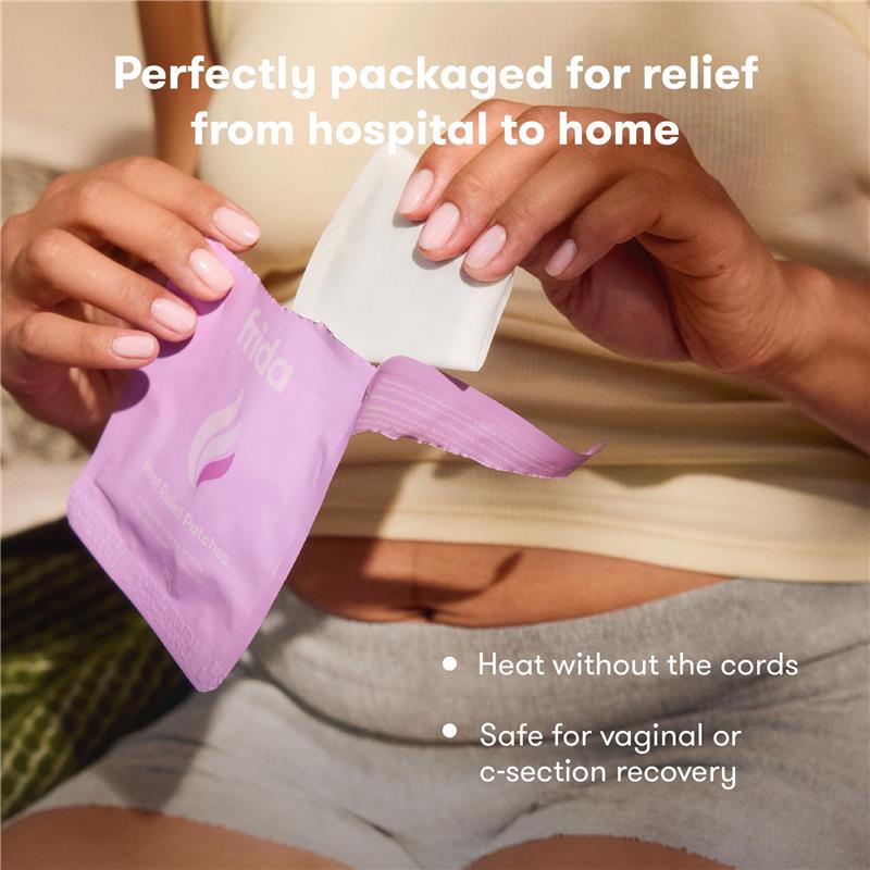 Frida Mom Uterine Recovery Heat Relief Patches in a hand, designed for easy, cord-free heat relief after childbirth.