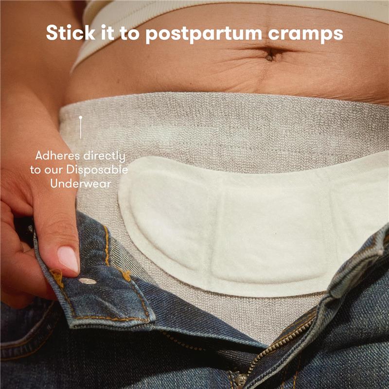 Frida Mom Uterine Recovery Heat Relief Patch adhered to gray disposable underwear, designed for postpartum cramp relief.