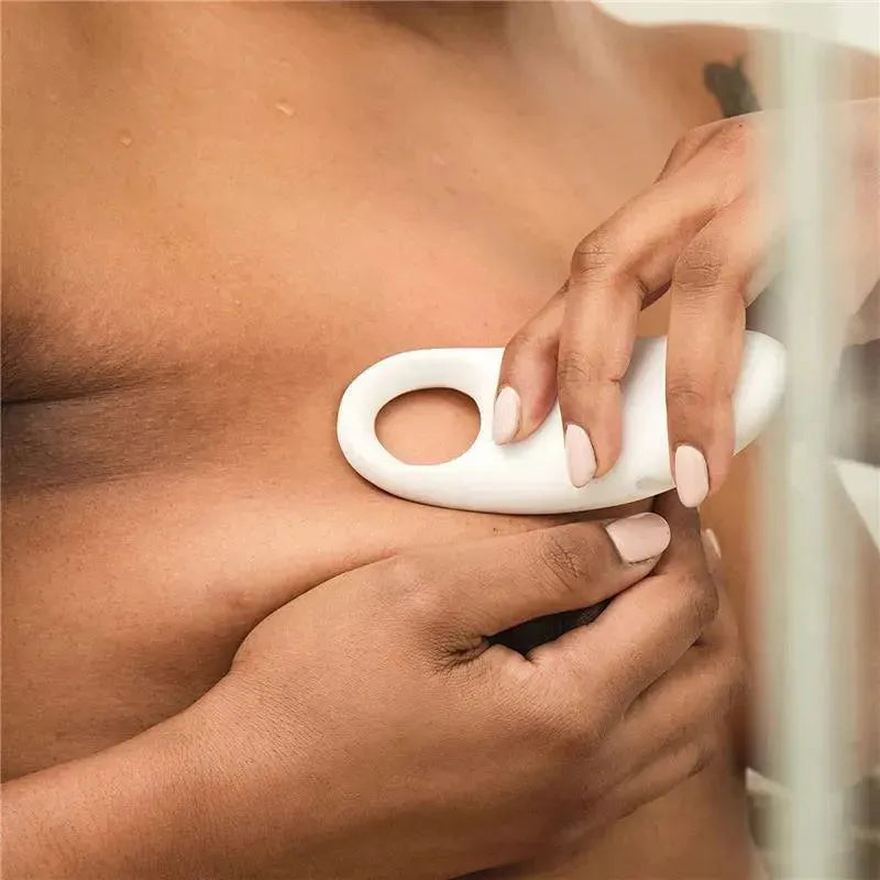 Frida Mom 2-In-1 Heat And Vibration Lactation Massager being used on the breast for comfort and relief.