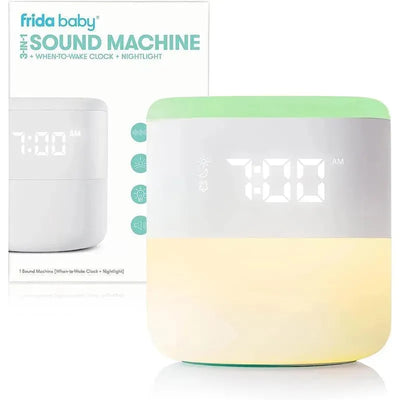 Fridababy 3-in-1 Sound Machine features a digital clock displaying 7:00 AM, nightlight, and sound options in a sleek design.