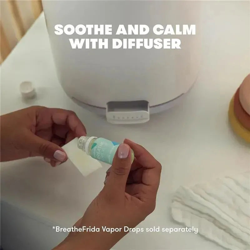 Fridababy 3-in-1 XL Cool Mist Humidifier with a person adding essential oil to a diffuser, promoting soothing effects.