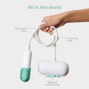 Fridababy Control The Flow Bathtub Sprayer Attachment held in a hand, featuring a long-reach hose and stay-put suction pump.