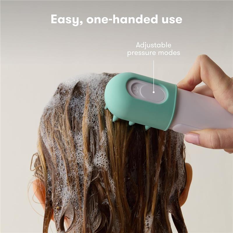 Fridababy Control The Flow Bathtub Sprayer attachment, designed for easy one-handed use, shown spraying water on soapy hair.