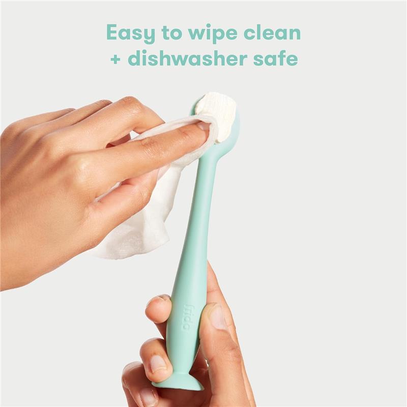 Fridababy Diaper Cream Booty Brush in mint green being cleaned with a wipe, highlighting its easy-to-clean and dishwasher-safe features.