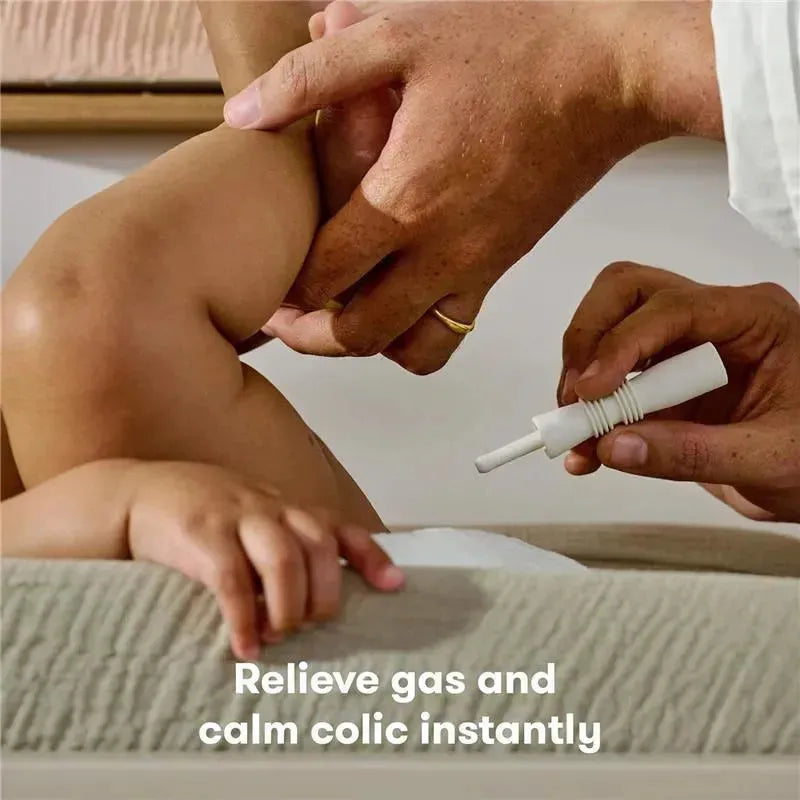 Hands of an adult applying FridaBaby Fart Freeing Essentials on a baby to relieve gas and calm colic.