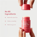 FridaBaby Gassy Belly Rub stick held in a hand, featuring details about its natural ingredients and soothing properties.