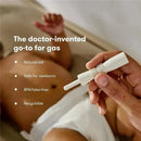 FridaBaby Fart Freeing Essentials shown in use, featuring a hand holding a white product designed for easing gas in newborns.