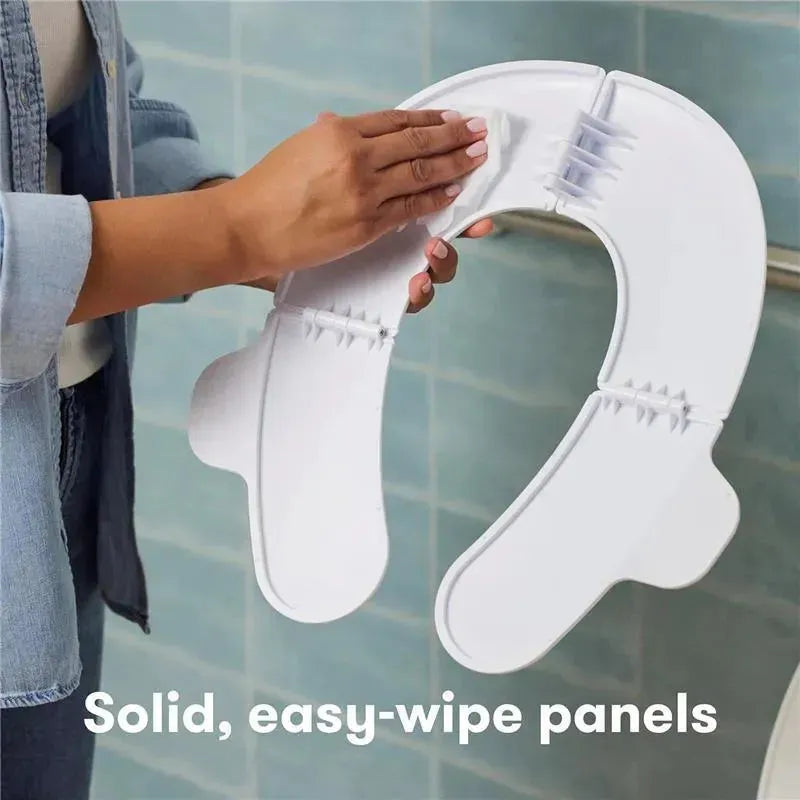 Fold-and-Go Potty Seat held by a person, featuring solid, easy-wipe panels, ideal for toddler travel use.