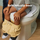 Foldable travel potty seat for toddlers on a toilet, featuring a child sitting safely with a non-slip base.