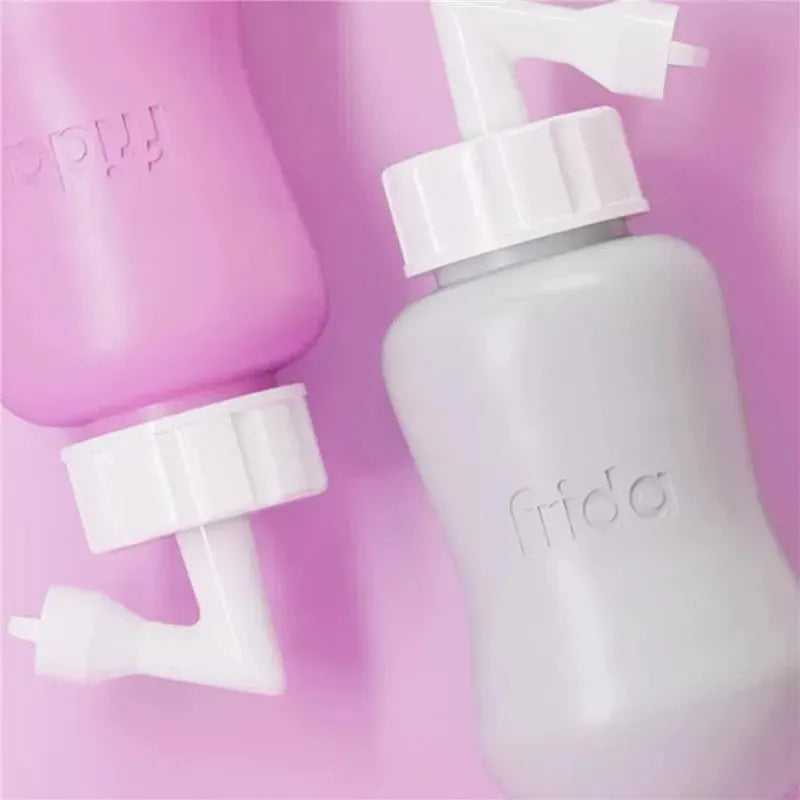 Postpartum Upside Down Peri Bottle by Frida Mom in pink and gray, designed for postpartum care with angled nozzles.