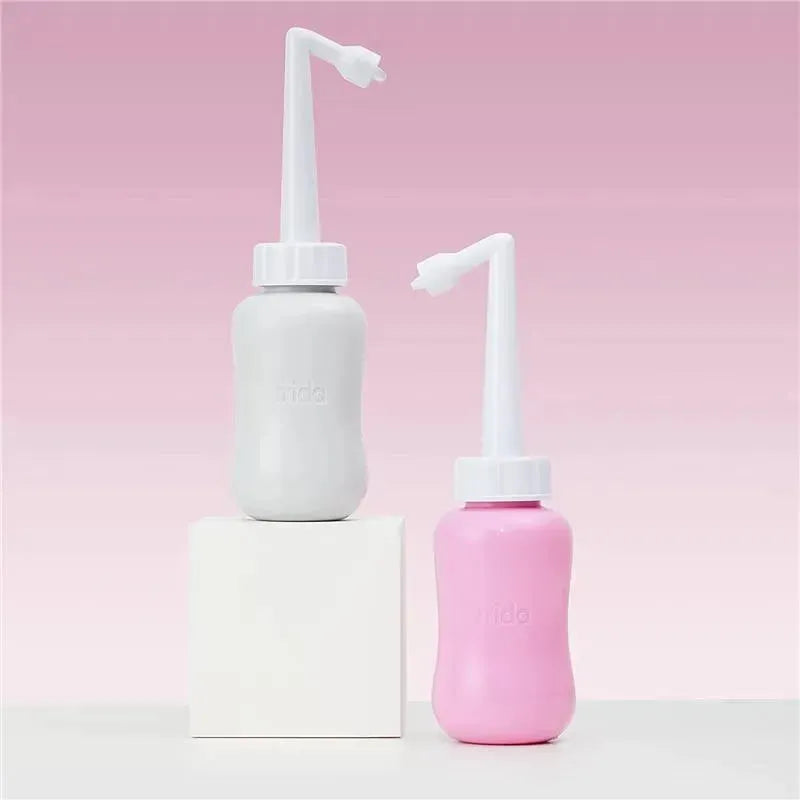 Frida Mom postpartum upside down peri bottles in gray and pink, designed for postpartum hygiene.