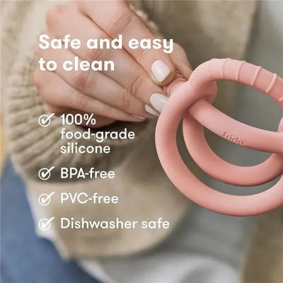 Muted pink teether from FridaBaby, made of 100% food-grade silicone; features include BPA-free, PVC-free, and dishwasher safe.