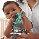 Baby holding a vibrant teal FridaBaby Get-A-Grip Teether, designed for easy grasping, with a hand visible in the background.