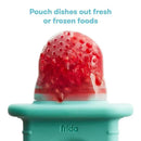 Teal Fridababy Push Pop Feeder with fresh fruit, designed for babies to easily ingest soft foods.