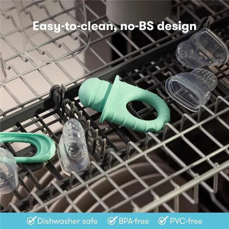Teal Fridababy Push Pop Feeder with clear silicone nipple parts, placed in a dishwasher, emphasizing easy cleaning.
