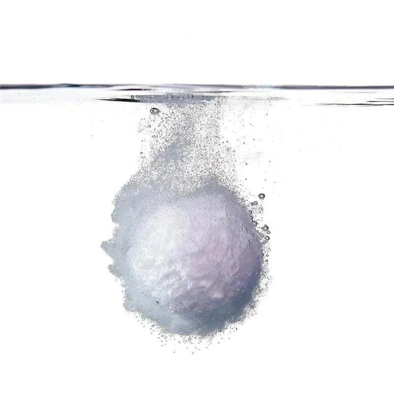 Lavender-colored bath bomb dissolving in water, creating bubbles, part of the Fridababy SleepFrida Vapor Bath Bombs.