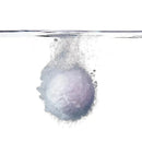 Lavender-colored bath bomb dissolving in water, creating bubbles, part of the Fridababy SleepFrida Vapor Bath Bombs.