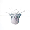 Fridababy SleepFrida Vapor Bath Bomb splashing into water, surrounded by bubbles and water droplets.