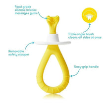 Training toothbrush for babies with soft silicone bristles, easy-grip handle, and a removable safety stopper.