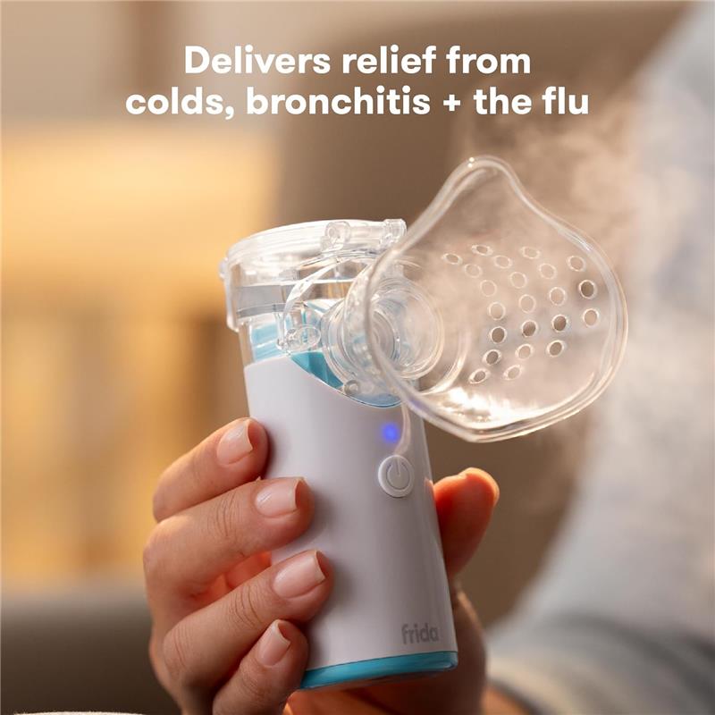 Portable nebulizer by Fridababy, emits mist from a clear mask, providing relief for colds, bronchitis, and flu.