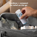 Ultra-quiet portable nebulizer in hand, being removed from a grey bag with a shirt and towels visible inside.