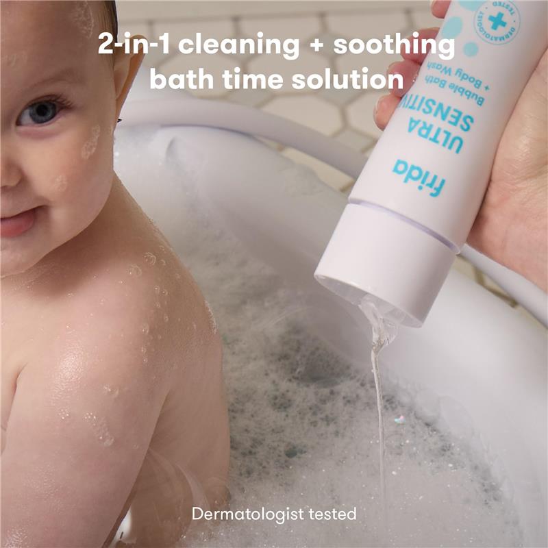 Fridababy Unscented Bubble Bath & Body Wash being poured into a bubbly bath with a smiling baby. Dermatologist tested.