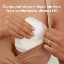 Disposable nursing pad being applied to skin, highlighting its contoured shape and features for comfort and discretion.