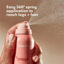FridaMom Leg + Foot Spray being applied, featuring a 360° spray nozzle for easy use on legs and feet.