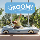 Convertible kids air mattress by FUNBOY, featuring a boy in a yellow shirt lounging and stretching on it.